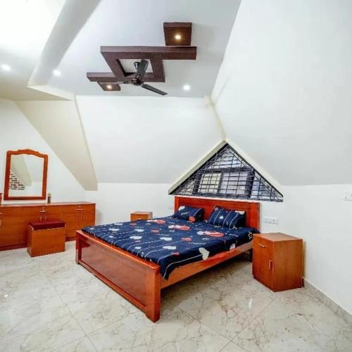 een slaapkamer met een bed en een raam aan het plafond bij susil house villa in Vellore