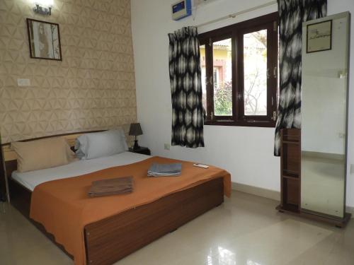 a bedroom with a bed and a window at Services (Self Catering) Villas 8 and 9 in Anjuna