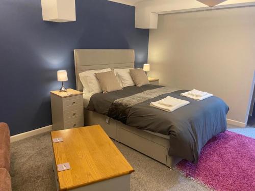 a bedroom with a bed and a wooden table at Y Teifi in Llandysul