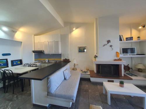 a kitchen and living room with a counter and a table at Endless Blue Villa - Amazing Sea view in Agia Pelagia