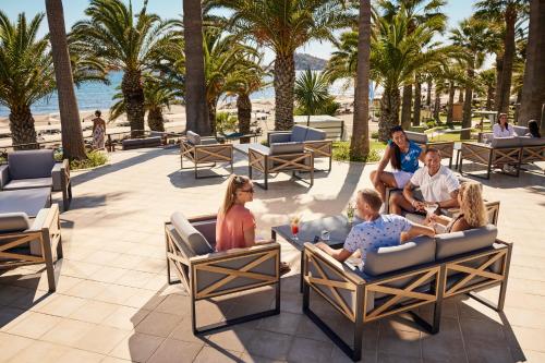 a group of people sitting in chairs on the beach at ROBINSON SARIGERME PARK - All Inclusive in Dalaman