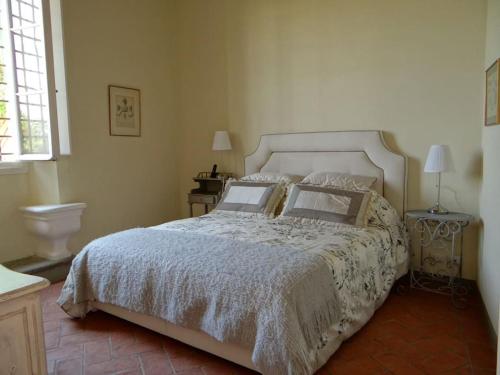 a bedroom with a white bed with two pillows at Pian dei Giullari Suite in Florence