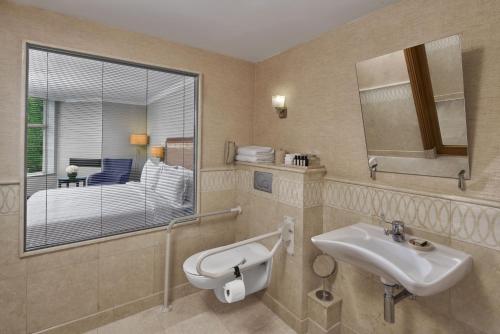 a bathroom with a sink and a mirror at Divan Ankara in Ankara