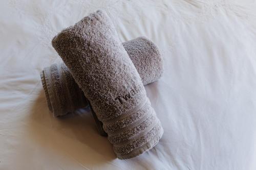 two stuffed animals are laying on a bed at Twalap in Paternoster
