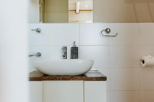 a bathroom with a white sink on a counter at Twalap in Paternoster