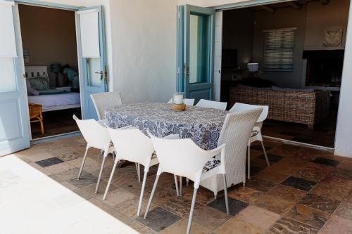 a dining room with a table and chairs at Twalap in Paternoster