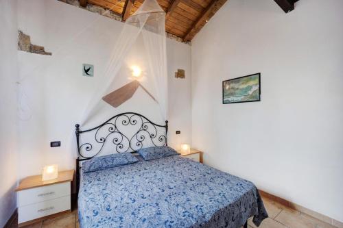a bedroom with a bed with a blue comforter at L'angolo del Mare in Pompeiana
