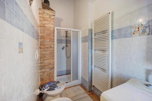 a bathroom with a shower and a toilet and a sink at L'angolo del Mare in Pompeiana