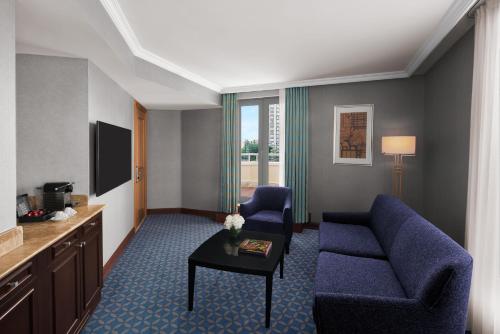 a living room with a couch and a tv at Divan Ankara in Ankara
