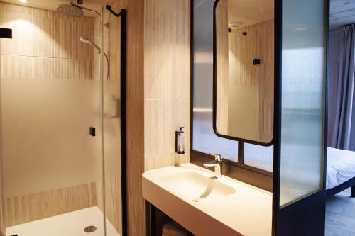 a bathroom with a sink and a mirror at Campanile Saint Brieuc - Centre Gare in Saint-Brieuc