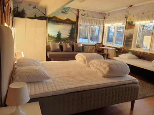 Säfsen Stay في لودفيكا: غرفة نوم بثلاث اسرة وصالة جلوس