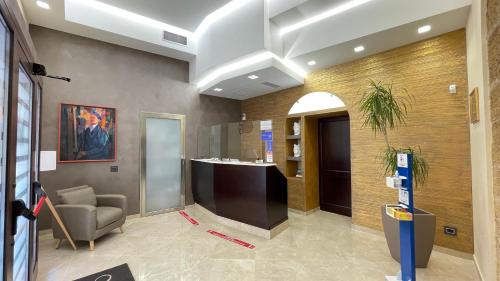 a lobby with a reception desk in a building at Vittorio Emanuele Boutique Hotel in Sciacca