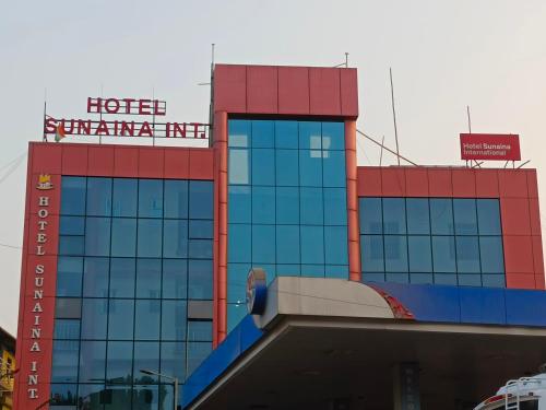 a hotel with a sign on top of a building at Hotel Sunaina International in Gaya
