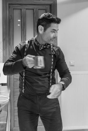 a man holding a coffee cup in his hands at Xenonas Kypseli in Kipseli