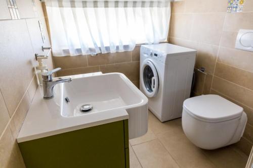 a bathroom with a sink and a washing machine at VastoMare - appartamento Vasto Marina in Vasto