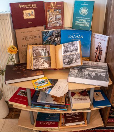 a pile of books sitting on a table at Xenonas Kypseli in Kipseli