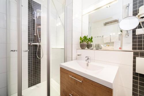 a bathroom with a sink and a shower at Hotel Trattnig in Döbriach