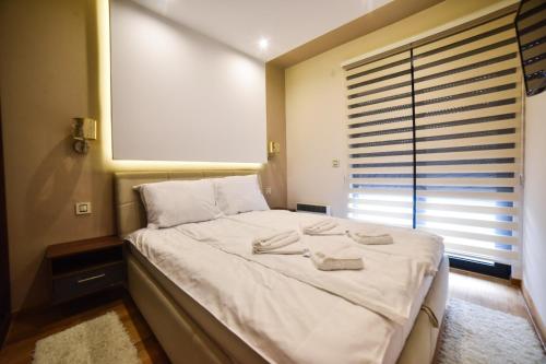 Ένα ή περισσότερα κρεβάτια σε δωμάτιο στο Apartman S1-2