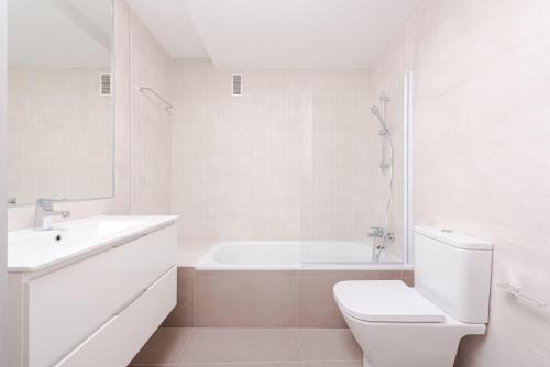 a white bathroom with a toilet and a sink at Los Robles Stylish & Modern 1 Bedroom Apartment in Madrid Conde Orgaz in Madrid