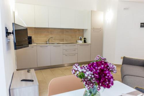 a kitchen with a vase of flowers on a table at VastoMare - appartamento Vasto Marina in Vasto