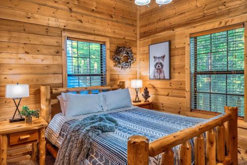 a bedroom with a bed in a log cabin at Pine Haven Hollow in Pigeon Forge