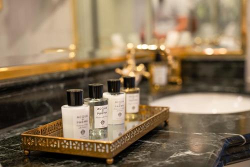 four bottles of moisturizers sitting on a counter in a bathroom at Steigenberger Icon Wiltcher's in Brussels