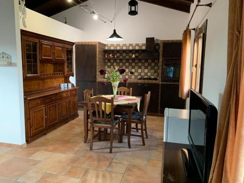 a kitchen with a table and chairs in a kitchen at Momon1616 Intero Chalet in Galatina