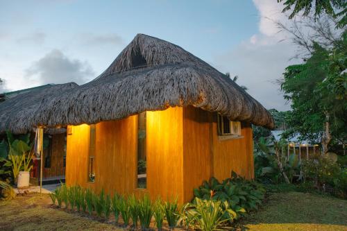 a small house with a thatched roof at Your Brothers House Tribal Village in Legazpi