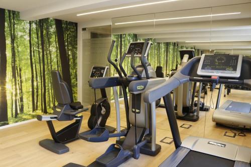 a gym with treadmills and elliptical machines at AR Boutique Apartments in Bergamo