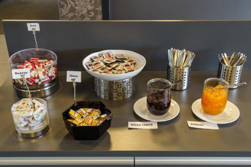 a counter with different types of snacks and drinks at Backpackers Villa Sonnenhof - Hostel Interlaken in Interlaken