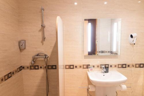 a bathroom with a sink and a shower at Hotel Golf Natura in La Coma i la Pedra