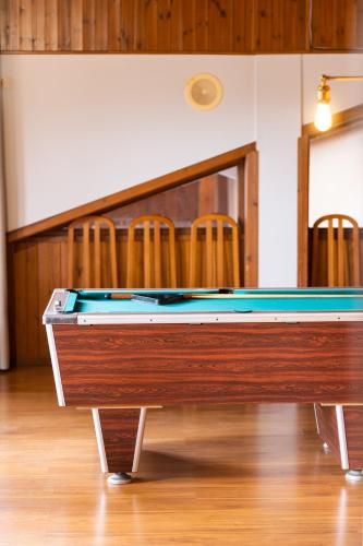 a pool table in a room with chairs at Hotel Golf Natura in La Coma i la Pedra