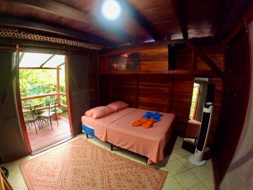 a bedroom with a bed with towels on it at Pirate and Mermaid Beach House in Puerto Viejo