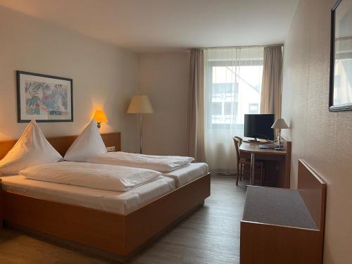 Ένα ή περισσότερα κρεβάτια σε δωμάτιο στο Hotel Aulmann