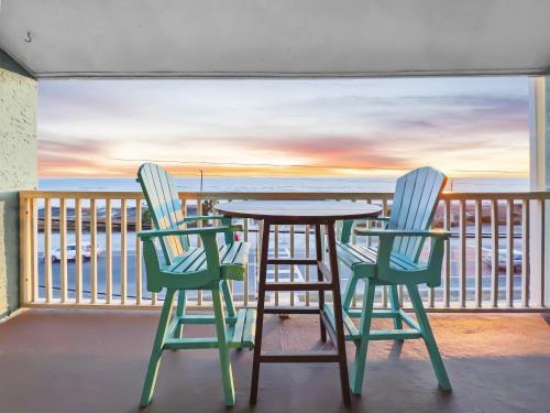a table and chairs on a balcony with a view of the ocean at Laguna Lookout in Panama City Beach