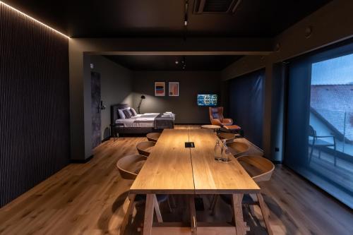 a conference room with a wooden table and chairs at OTTON-Charzykowy Bed&Restaurant in Chojnice