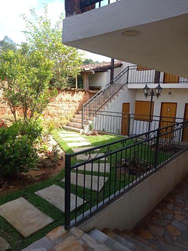 a stairway leading to a house with a fence at Pouso Casa da Vovó in Tiradentes