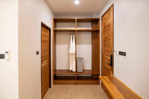 a walk in closet with a wooden door at Ao Luek Panoramic Pool-SHA Plus in Ao Luk
