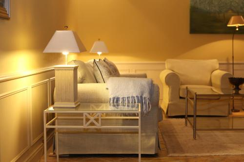 ein Wohnzimmer mit einem Sofa und einem Stuhl in der Unterkunft Ferienwohnungen Biberhüs in Archsum