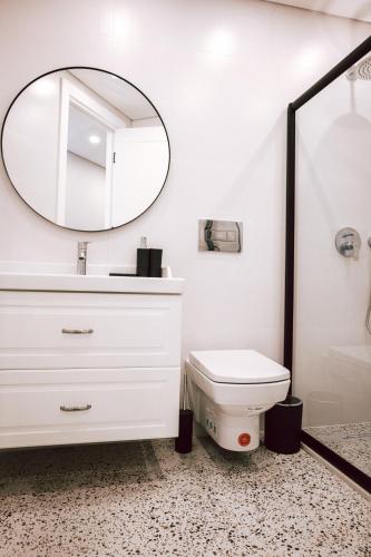 a bathroom with a white sink and a mirror at Bolahenk Suites in Istanbul