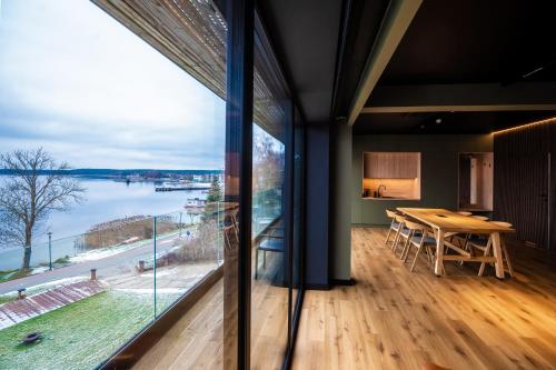 a dining room with a table and a large window at OTTON-Charzykowy Bed&Restaurant in Chojnice