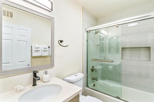 a bathroom with a sink and a glass shower at Seashore Dreams B - Upper Unit in Newport Beach