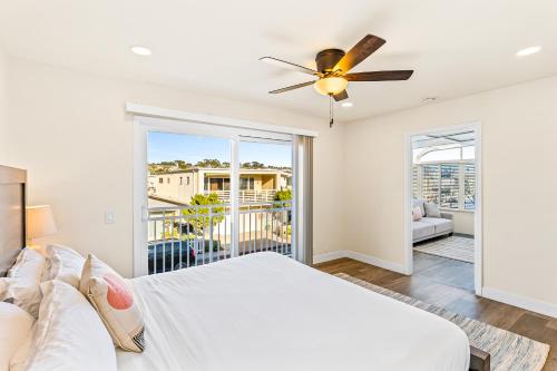 a bedroom with a bed and a ceiling fan at Seashore Dreams B - Upper Unit in Newport Beach