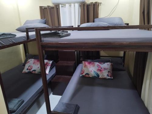 a group of bunk beds in a room at 8-pax Jumongs Transient in Bantay