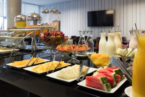 a buffet with cheese and fruit on a table at Frontier Hotel Rivera in Rivera