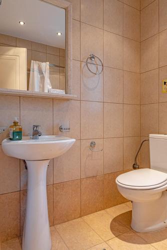 a bathroom with a sink and a toilet at Xenonas Kypseli in Kipseli