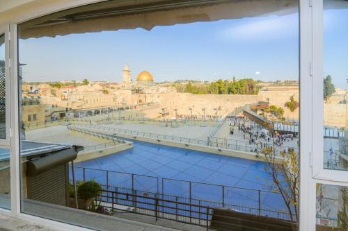a view from a window of the city of jerusalem at Western Wall View Apartment in Yerushalayim