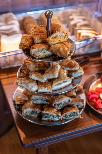 a three tiered tray of pastries on a table at Xenonas Kypseli in Kipseli