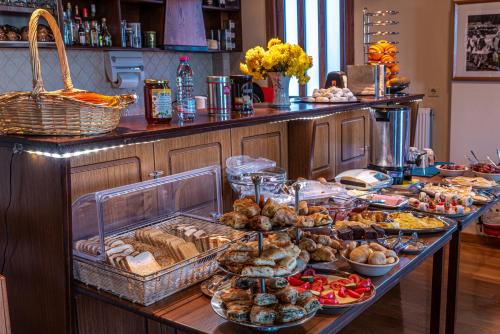 a buffet with many different types of food on a table at Xenonas Kypseli in Kipseli