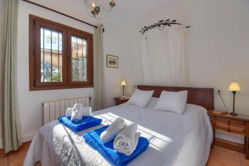 a bedroom with a bed with towels on it at Acuarela Vistas in Jávea